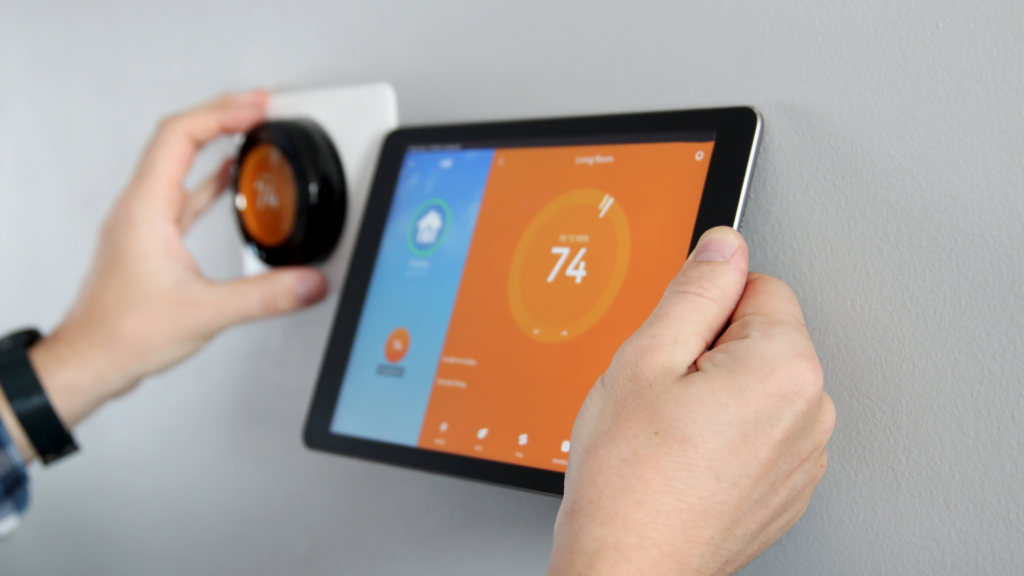 Person installing a smart thermostat in Lexington, Kentucky