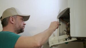 technician fixing a heater